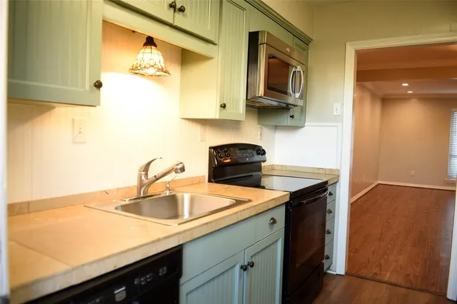 a kitchen with stainless steel appliances granite countertop a sink a stove and dishwasher