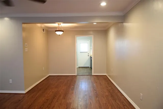 a view of a room with wooden floor and a window