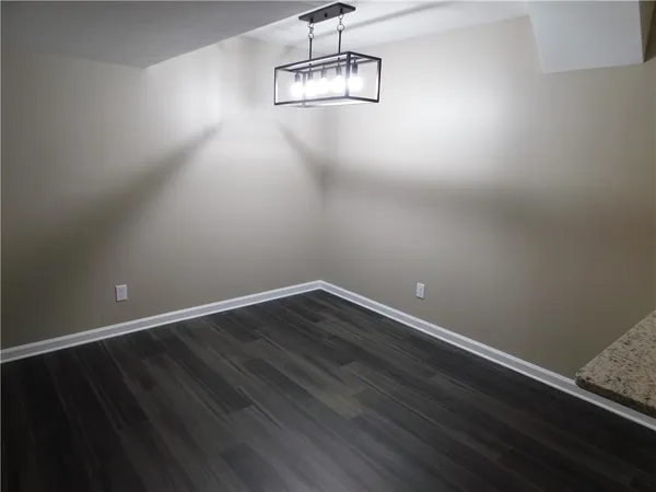 a view of a room with wooden floor and windows
