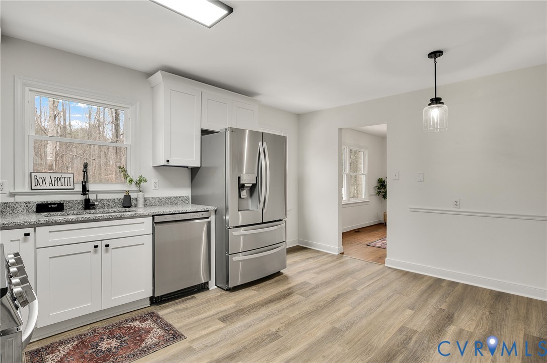 16430 St Peters Church Road Montpelier, VA 23192 - Photo 18 of 30 a kitchen with white cabinets and stainless steel appliances