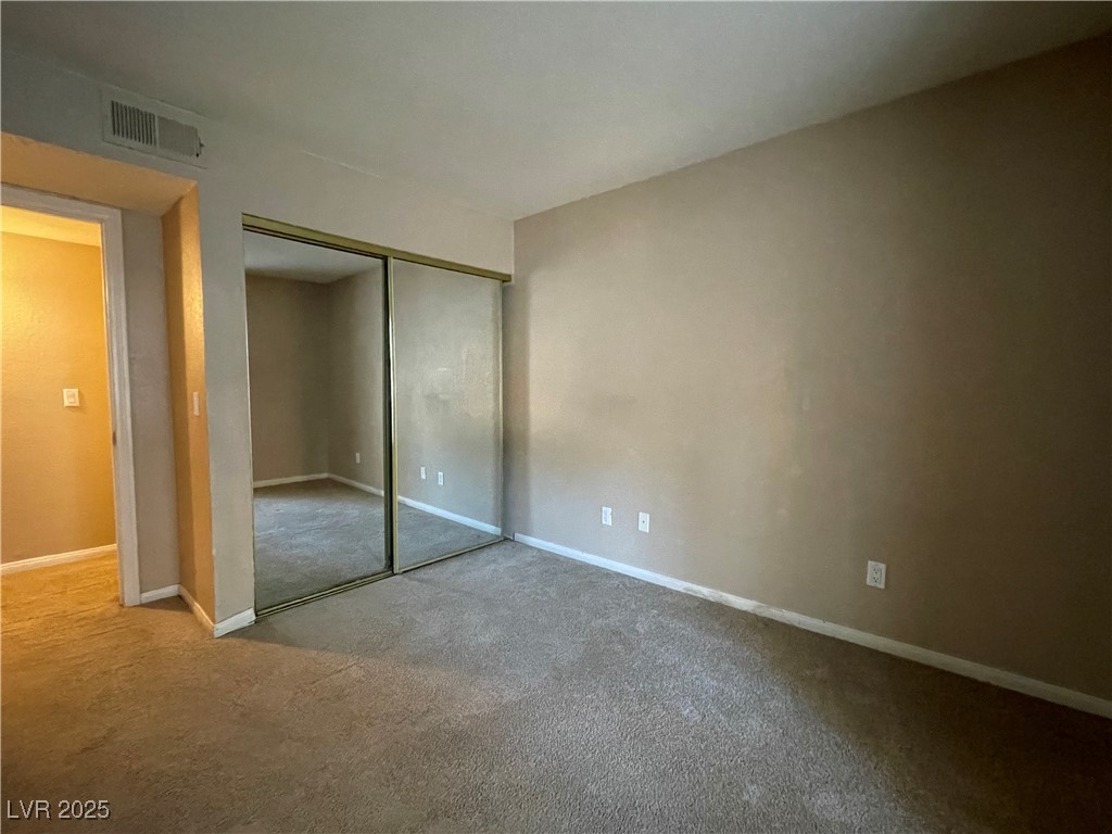 9325 West Desert Inn Road, Unit 149 Las Vegas, NV 89117 - Photo 11 of 20 Unfurnished bedroom with carpet and a closet