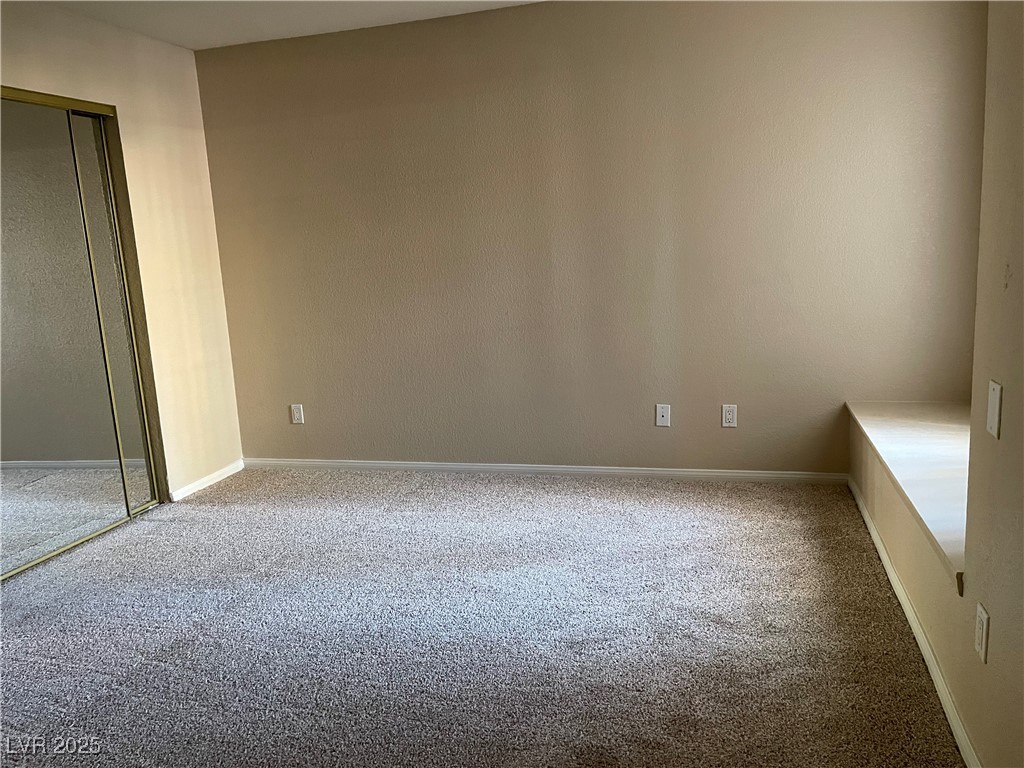9325 West Desert Inn Road, Unit 149 Las Vegas, NV 89117 - Photo 12 of 20 Unfurnished bedroom featuring carpet and a closet