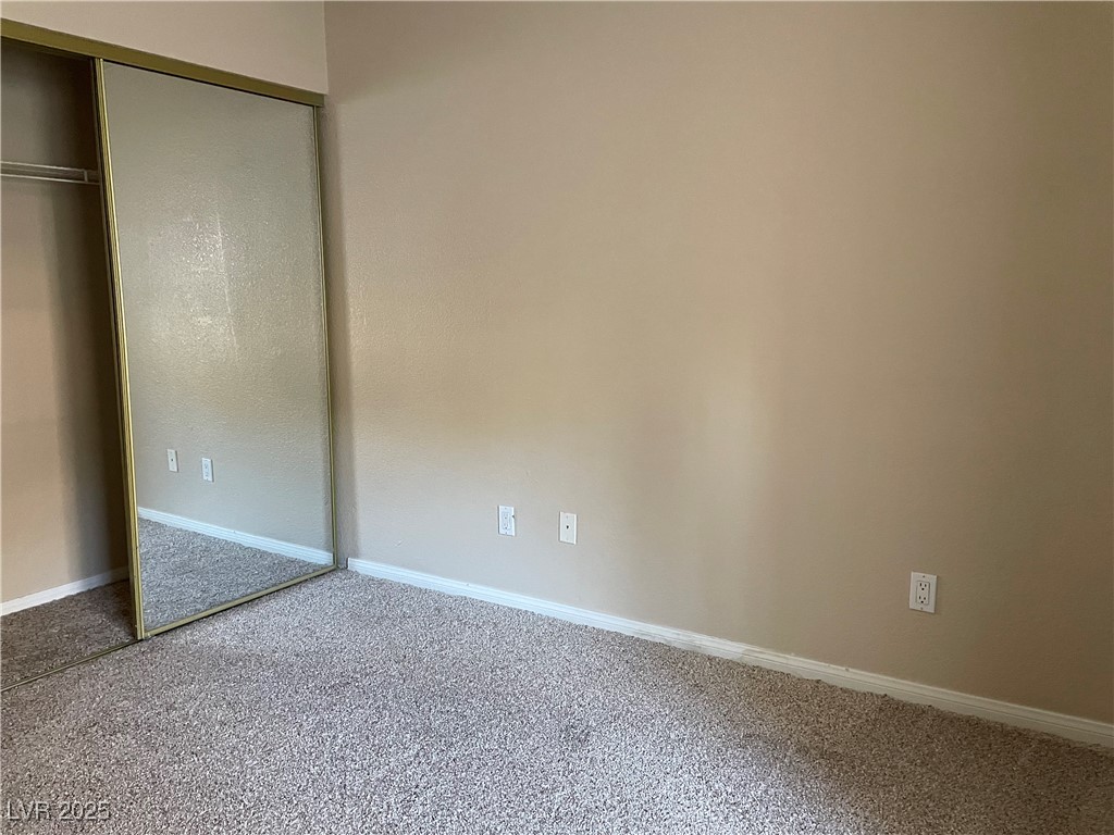 9325 West Desert Inn Road, Unit 149 Las Vegas, NV 89117 - Photo 13 of 20 Unfurnished bedroom with carpet floors and a closet