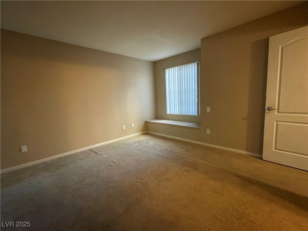 9325 West Desert Inn Road, Unit 149 Las Vegas, NV 89117 - Photo 15 of 20 Carpeted spare room with baseboards