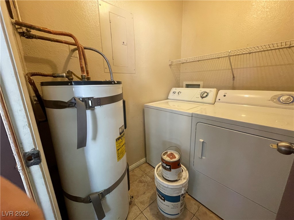 9325 West Desert Inn Road, Unit 149 Las Vegas, NV 89117 - Photo 19 of 20 Laundry room featuring secured water heater, a textured wall, light tile patterned floors, electric panel, and washer and dryer