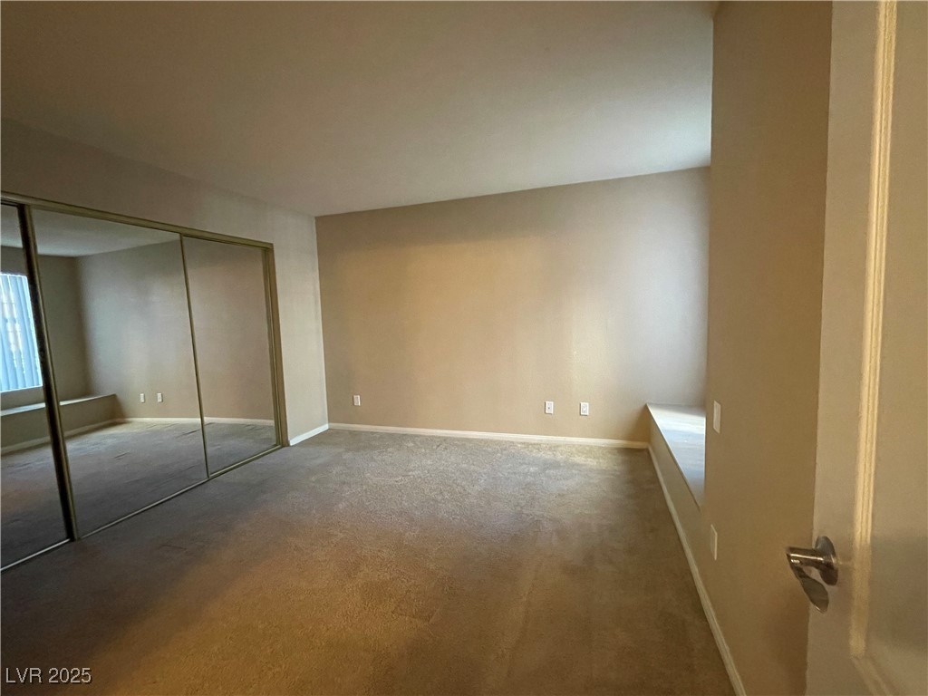 9325 West Desert Inn Road, Unit 149 Las Vegas, NV 89117 - Photo 6 of 20 Unfurnished bedroom featuring a closet and carpet