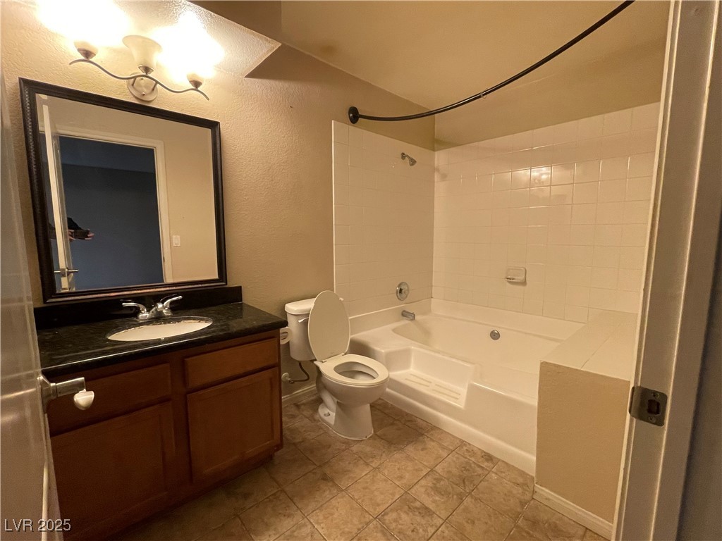 9325 West Desert Inn Road, Unit 149 Las Vegas, NV 89117 - Photo 7 of 20 Full bathroom featuring shower / bath combination, a textured wall, and vanity