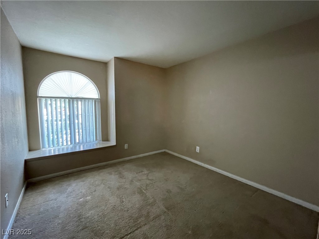 9325 West Desert Inn Road, Unit 149 Las Vegas, NV 89117 - Photo 8 of 20 Spare room featuring carpet and baseboards