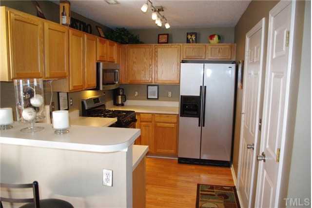 9015 Shallcross Way Raleigh, NC 27617 - Photo 2 of 12 a kitchen with stainless steel appliances a refrigerator and a sink