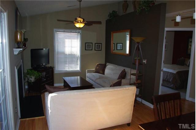 9015 Shallcross Way Raleigh, NC 27617 - Photo 5 of 12 a bedroom with a bed a window and potted plant on a table