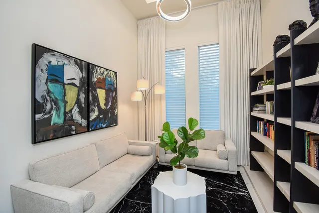 a living room with furniture and a potted plant