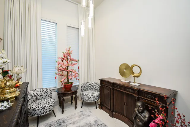 a living room with furniture and a painting on the wall