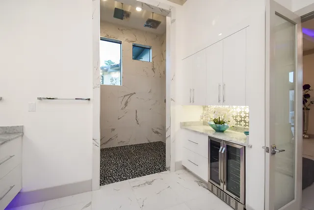 a spacious en suite bathroom with a double vanity sink and mirror
