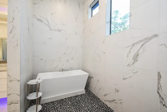 a bathroom with a granite countertop shower and a sink