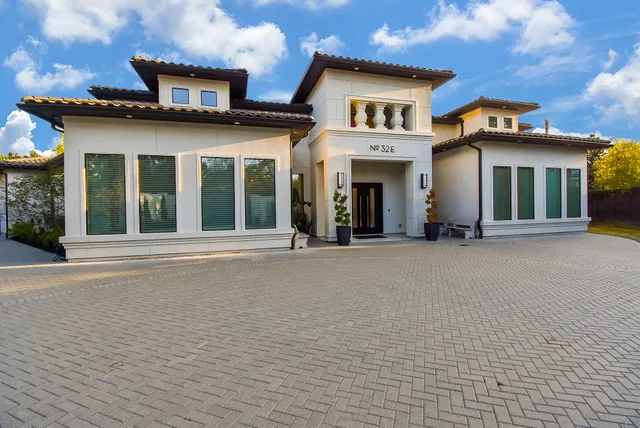 front view of a brick house with a large window