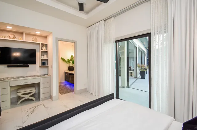 a bathroom with a granite countertop sink a potted plant and a shower
