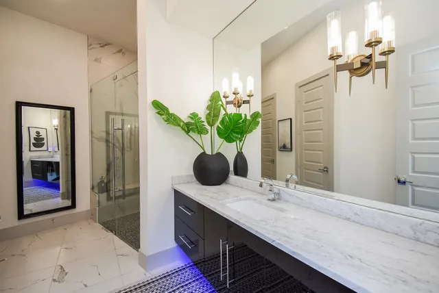 a bedroom with a large bed and a chandelier