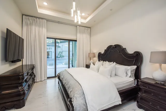a bedroom with a bed and a chandelier