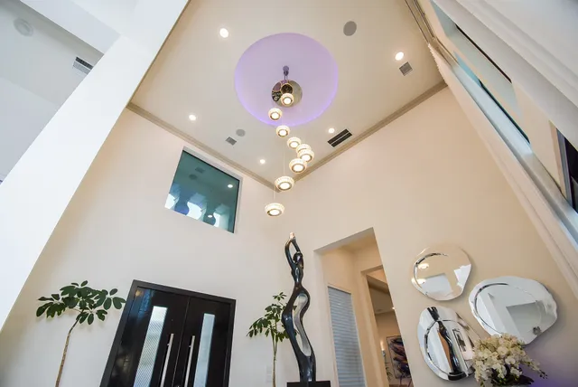 a living room with furniture a dining table and a chandelier