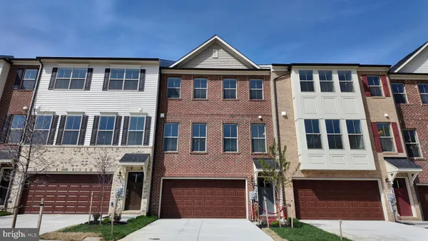 a front view of a house with glass windows and garage