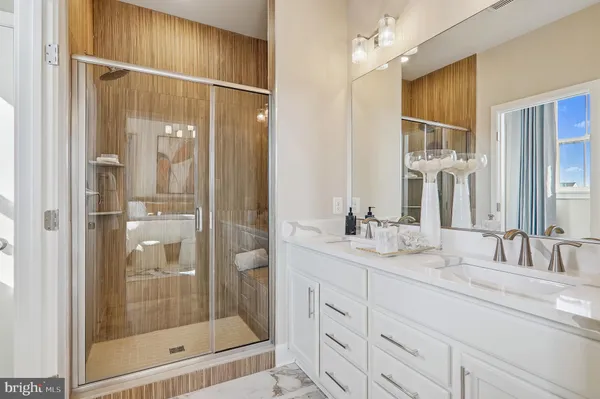 a bathroom with a shower sink and mirror