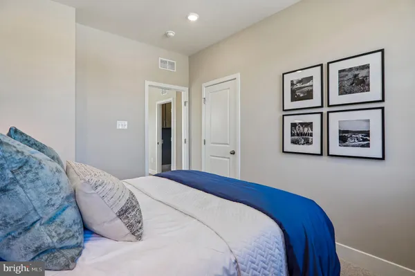 a bedroom with a bed and a wall painting