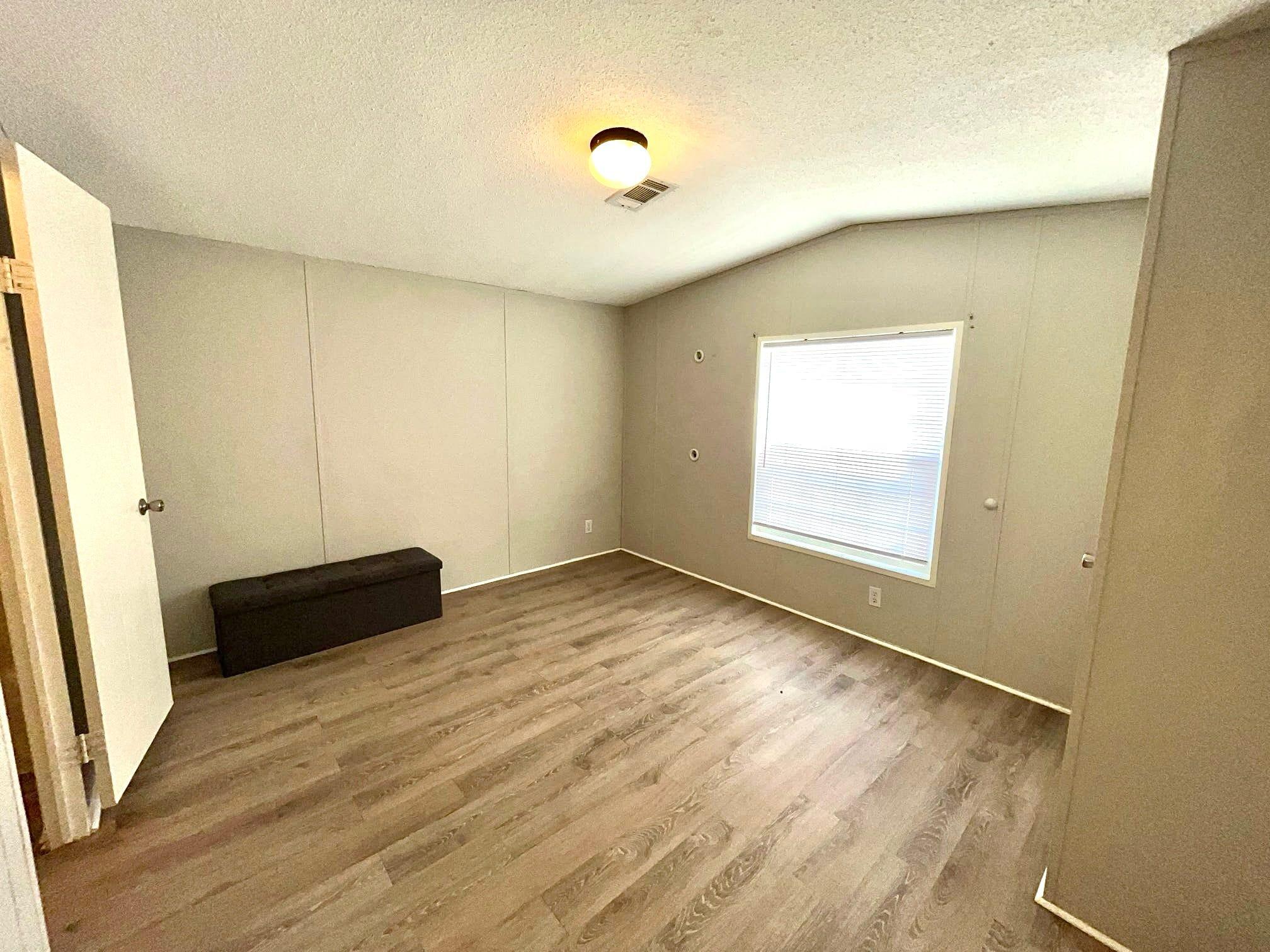 5000 Southeast Federal Highway, Unit 806 Stuart, FL 34997 - Photo 12 of 22 an empty room with wooden floor and windows