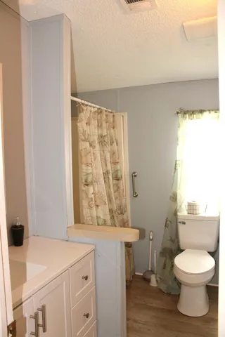 a bathroom with a toilet a sink and a window
