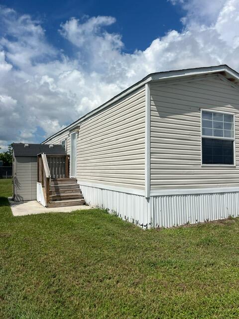 5000 Southeast Federal Highway, Unit 806 Stuart, FL 34997 - Photo 2 of 22 a front view of a house with a yard
