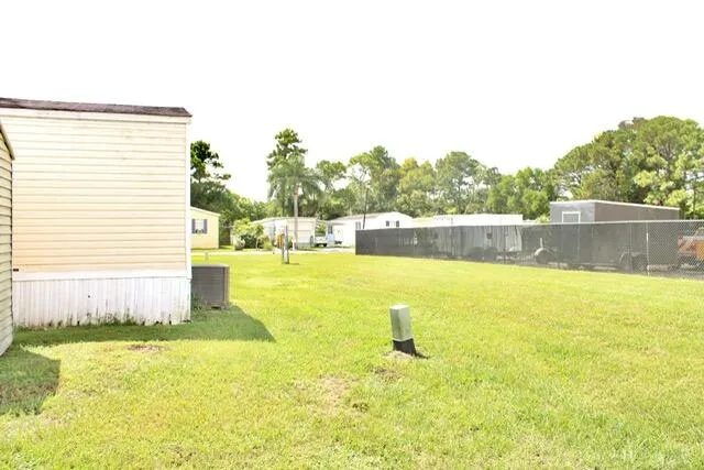 a view of a swimming pool with a yard