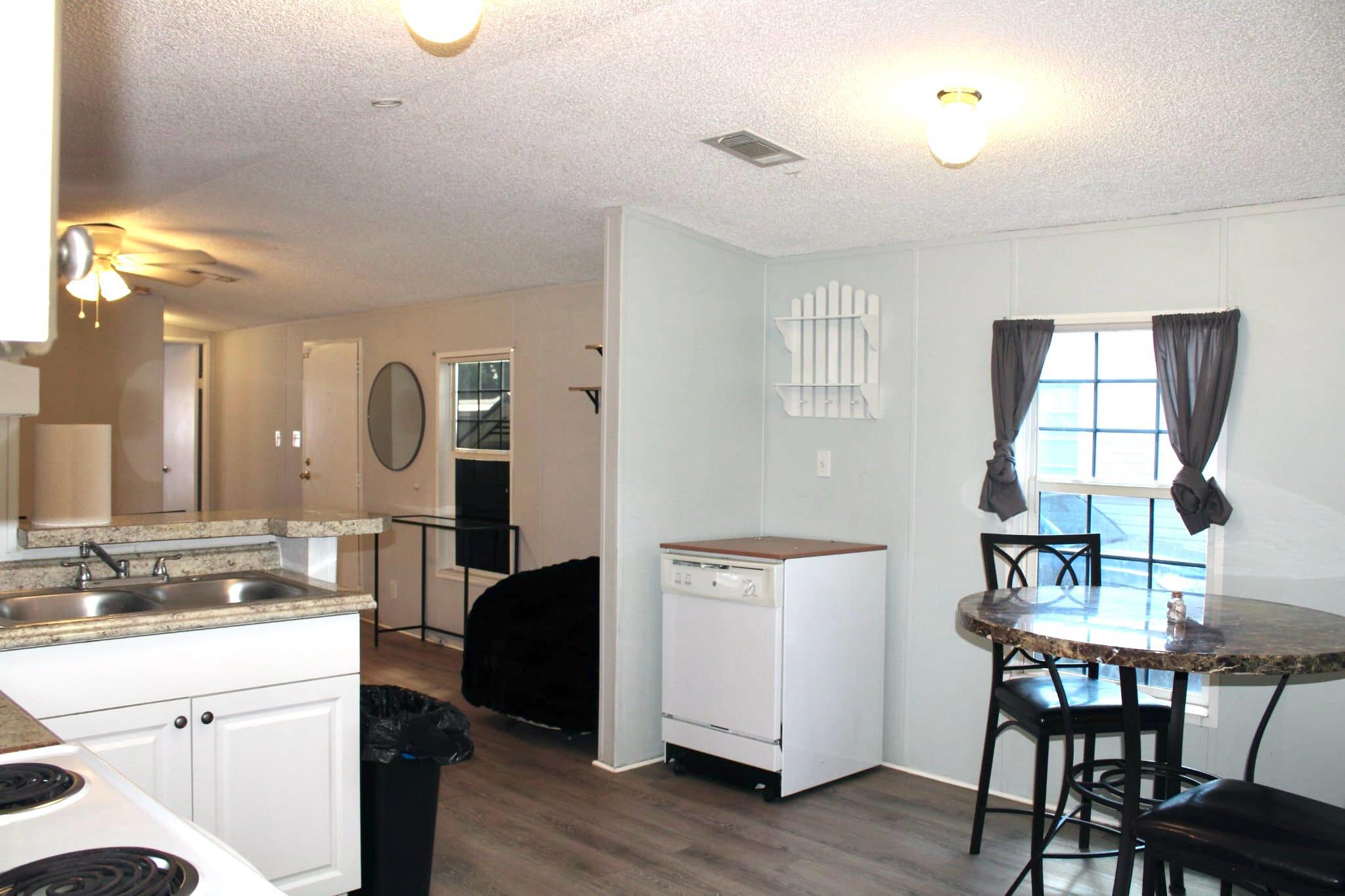 5000 Southeast Federal Highway, Unit 806 Stuart, FL 34997 - Photo 8 of 22 a view of a kitchen area with furniture and wooden floor