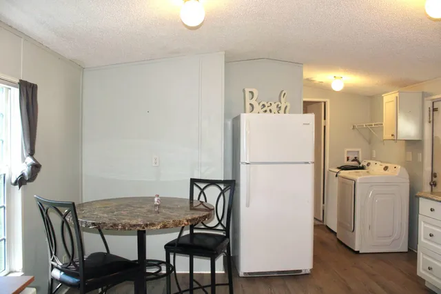 a white refrigerator freezer sitting next to a white cabinet