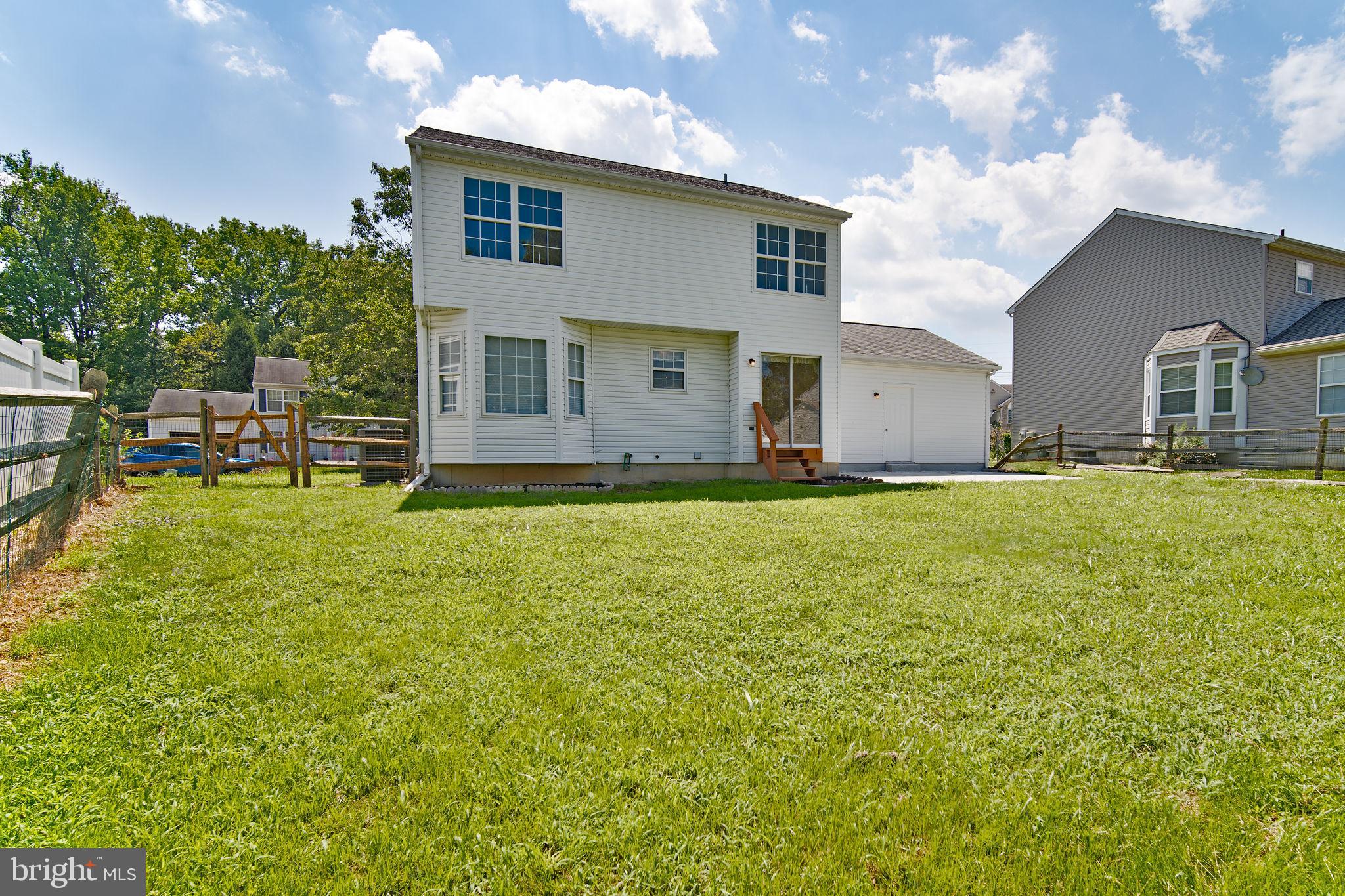 29 Bastille Loop Newark, DE 19702 - Photo 32 of 34 a front view of house with yard and trees in the background
