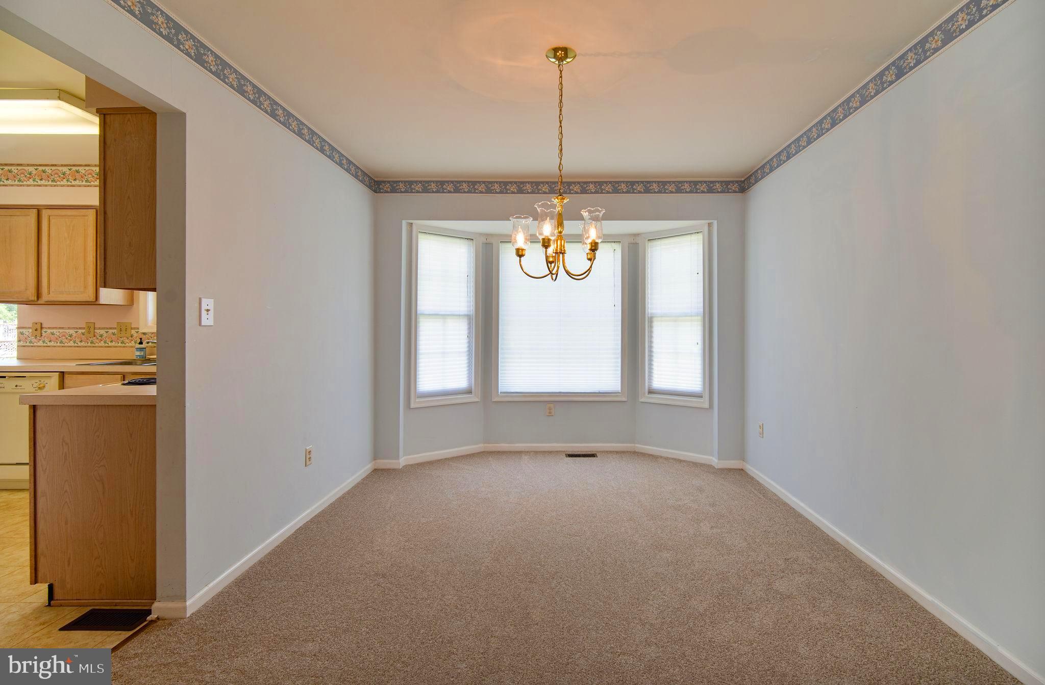 29 Bastille Loop Newark, DE 19702 - Photo 6 of 34 a view of an empty room with window and chandelier