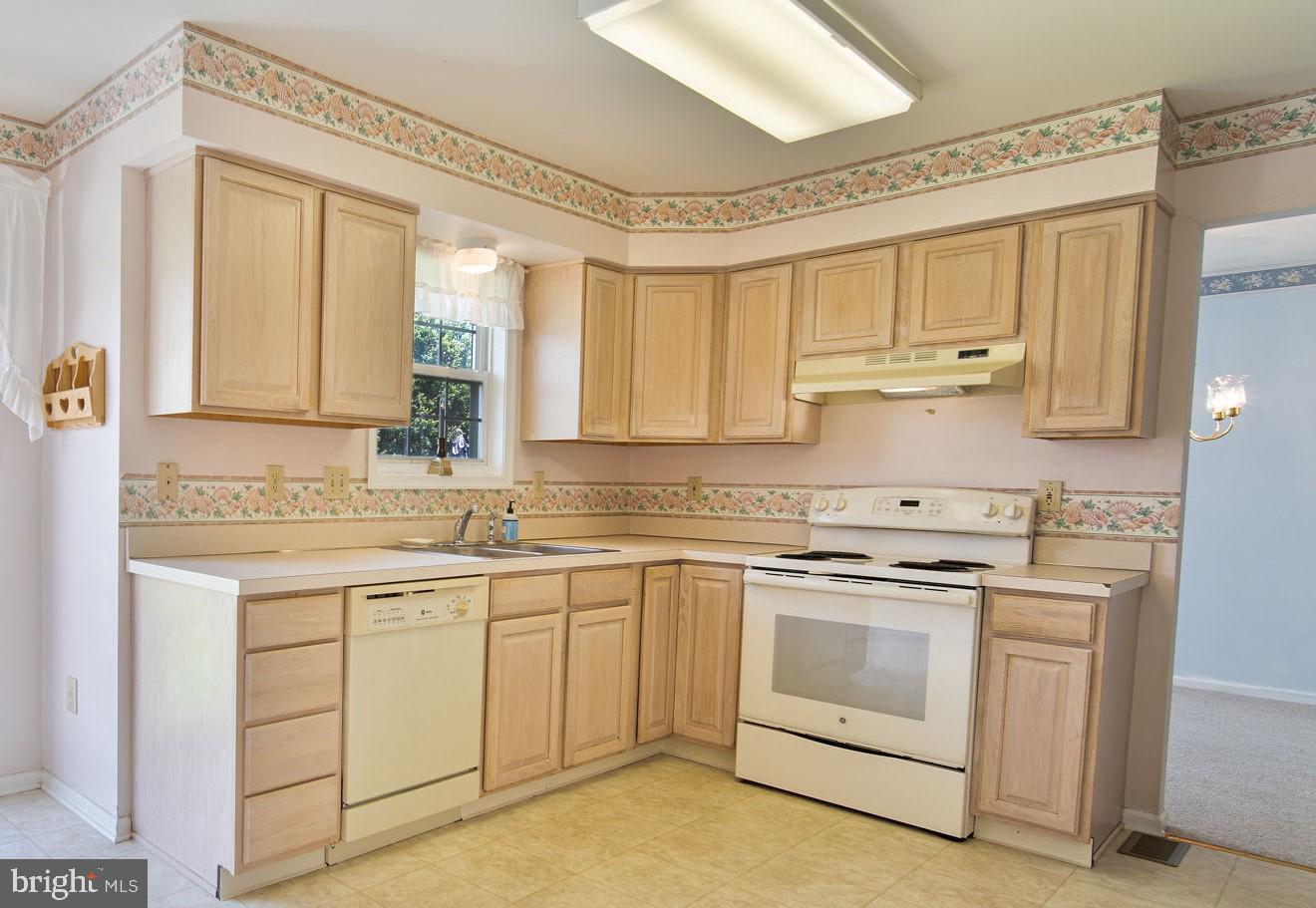 29 Bastille Loop Newark, DE 19702 - Photo 9 of 34 a kitchen with white cabinets and white appliances