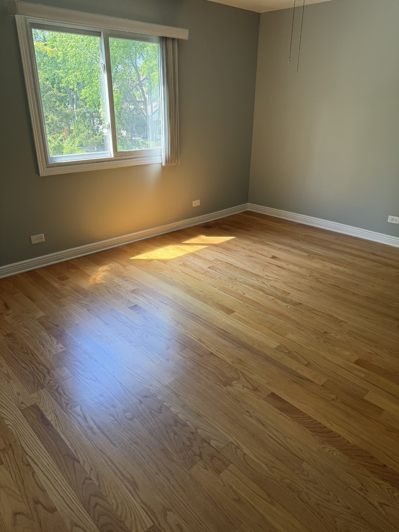 606 Bridgeport Place Wheeling, IL 60090 - Photo 21 of 25 an empty room with wooden floor and windows