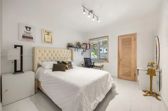 a bedroom with double bed and a window