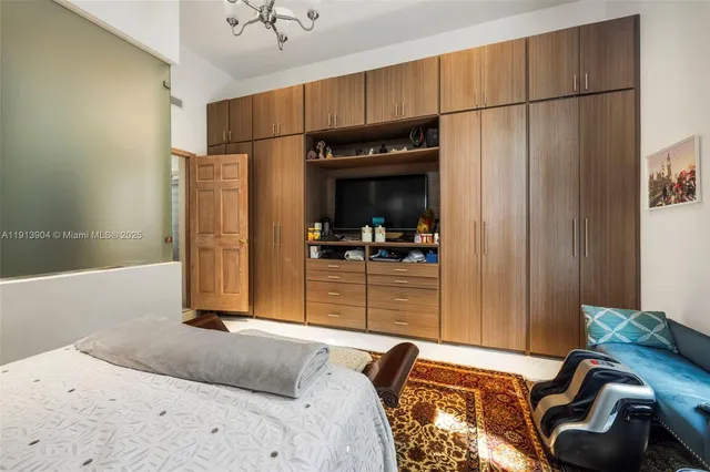 a bedroom with a bed and a mirror