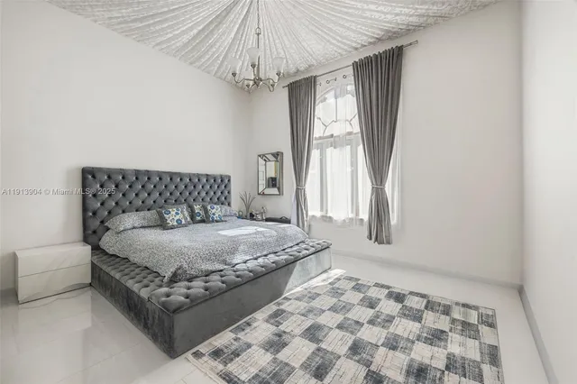 a bedroom with a bed and a chair