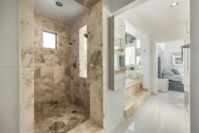 a bathroom with a glass shower door and a glass door shower