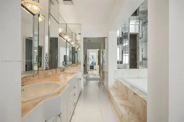 a bathroom with a tub sink and mirror