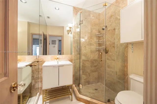 a bathroom with a sink toilet and shower