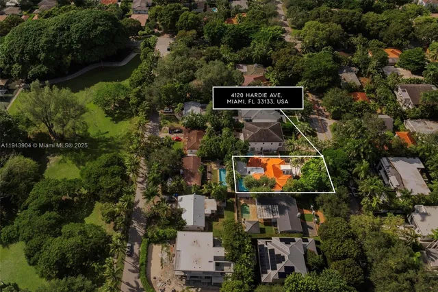 an aerial view of a house with swimming pool and garden