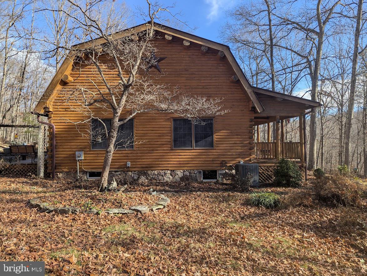 1537 Hidden Valley Road Franklin, WV 26807 - Photo 16 of 78 a backyard of a house with large trees and wooden fence