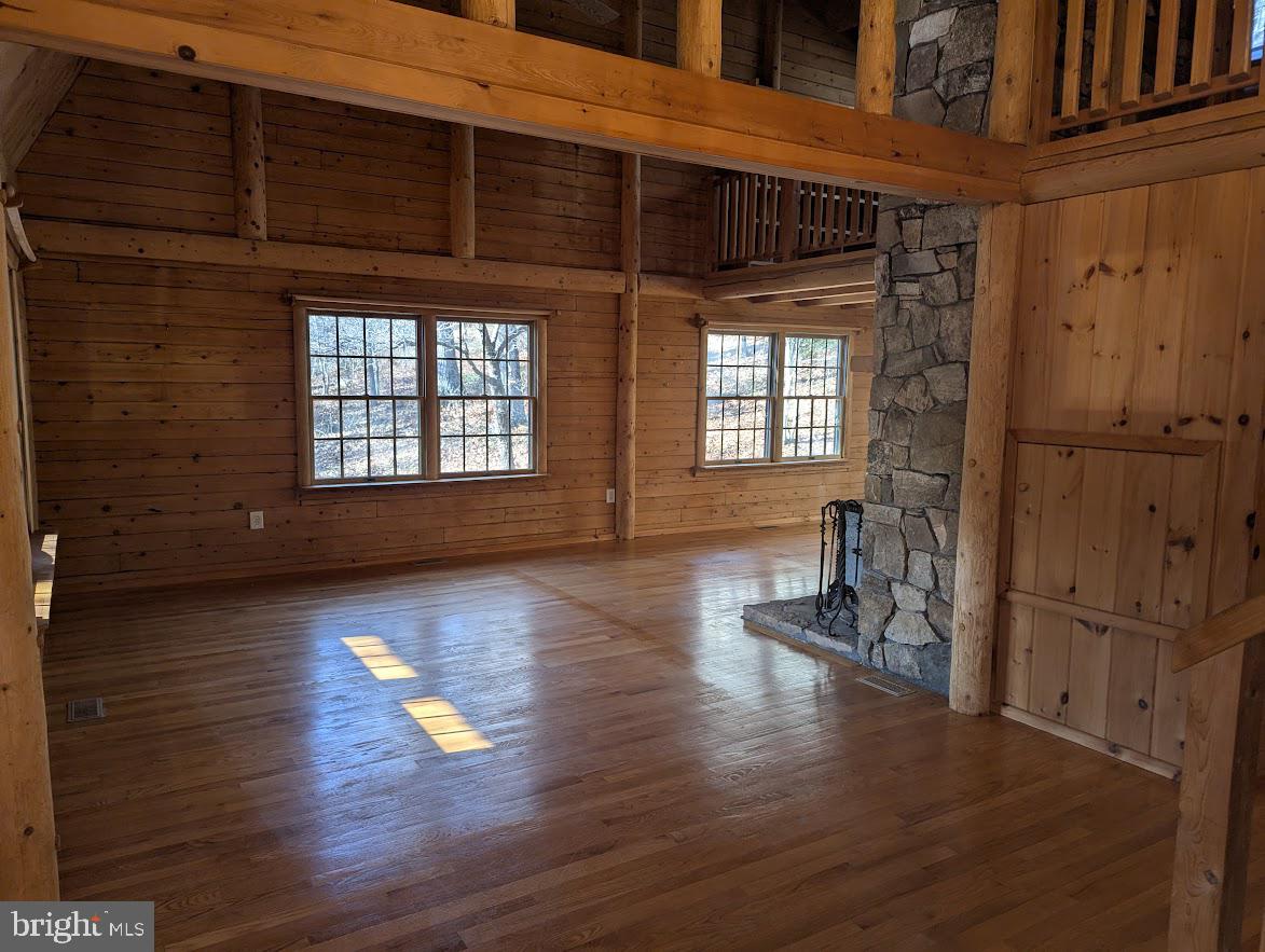1537 Hidden Valley Road Franklin, WV 26807 - Photo 2 of 78 a view of empty room with wooden floor and windows