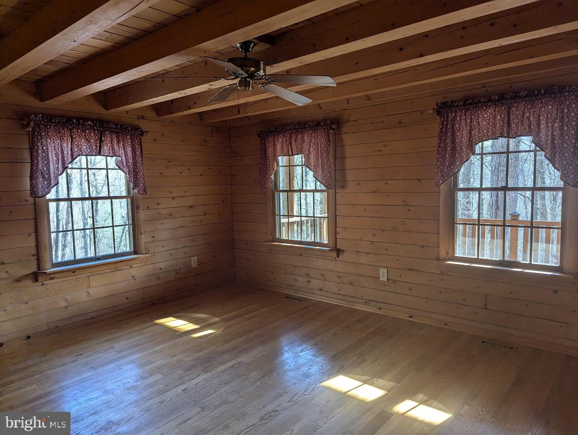 1537 Hidden Valley Road Franklin, WV 26807 - Photo 22 of 78 a view of an empty room with wooden floor and a window