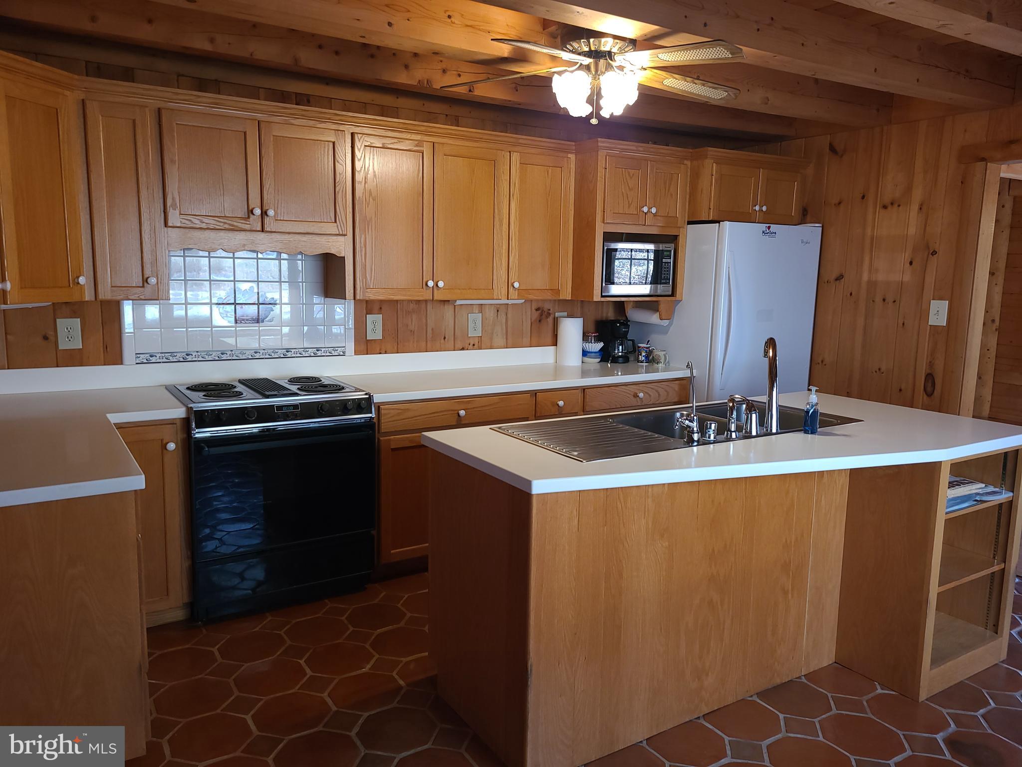 1537 Hidden Valley Road Franklin, WV 26807 - Photo 24 of 78 a kitchen with stainless steel appliances granite countertop a sink stove and refrigerator