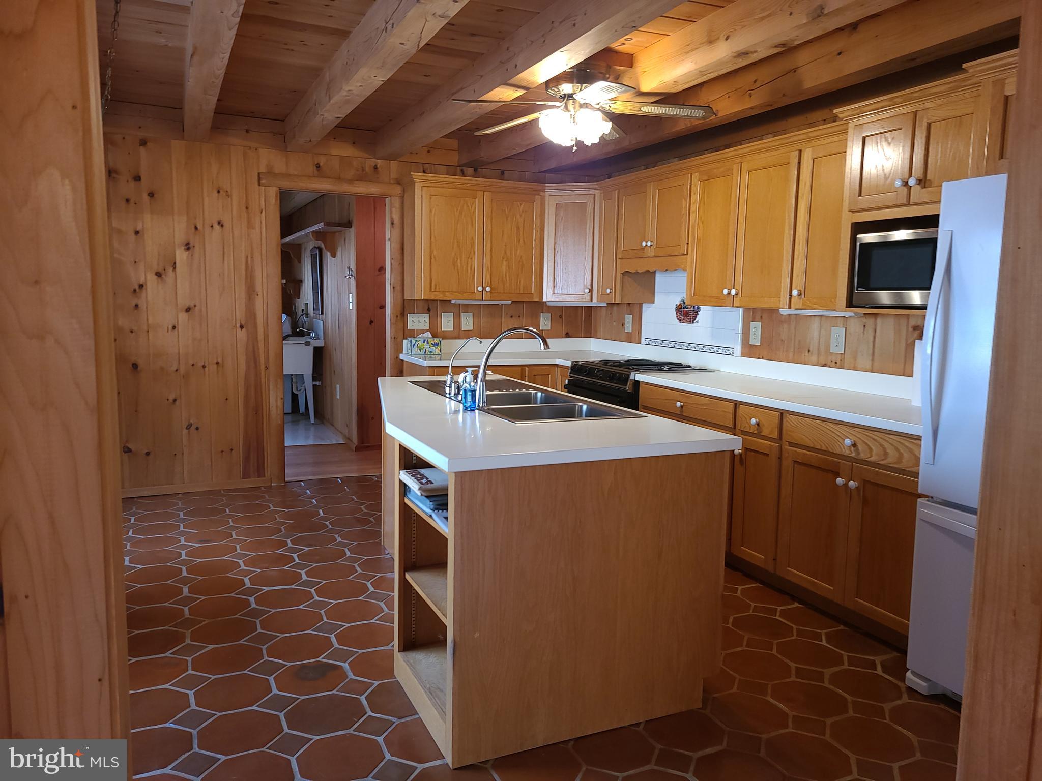 1537 Hidden Valley Road Franklin, WV 26807 - Photo 4 of 78 a kitchen with a sink a counter top space and stainless steel appliances