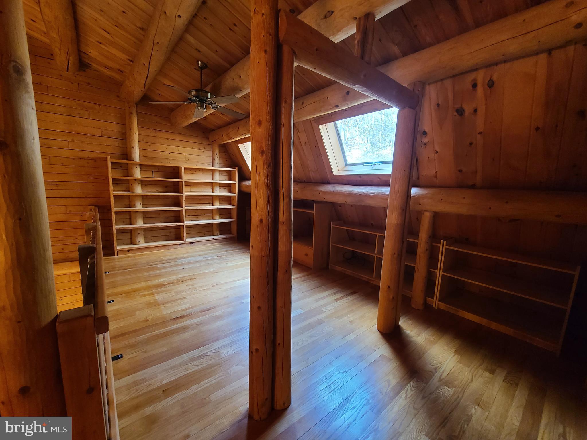 1537 Hidden Valley Road Franklin, WV 26807 - Photo 46 of 78 a view of an empty room with wooden floor and windows