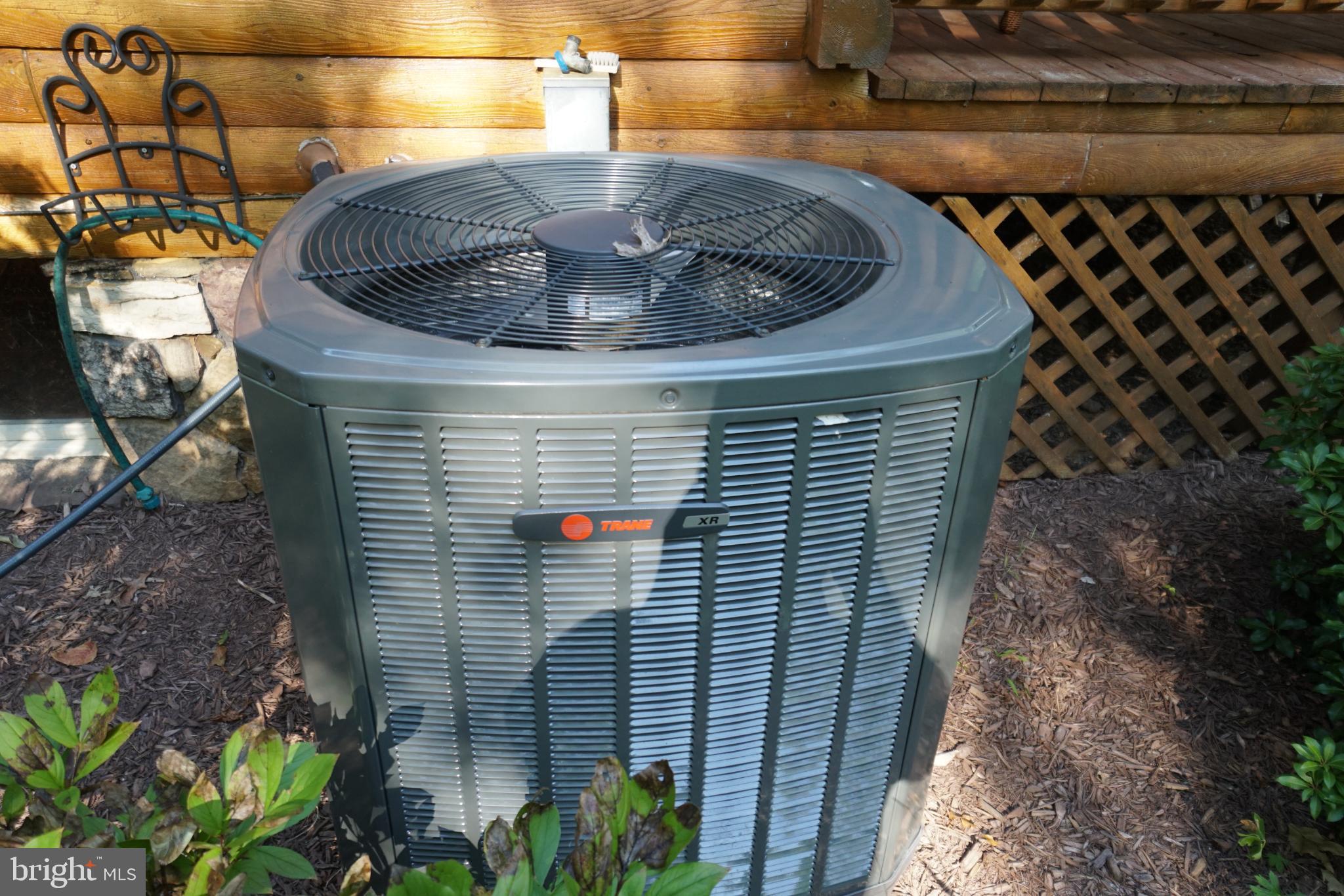 1537 Hidden Valley Road Franklin, WV 26807 - Photo 67 of 78 Efficient cooling unit in a serene garden.